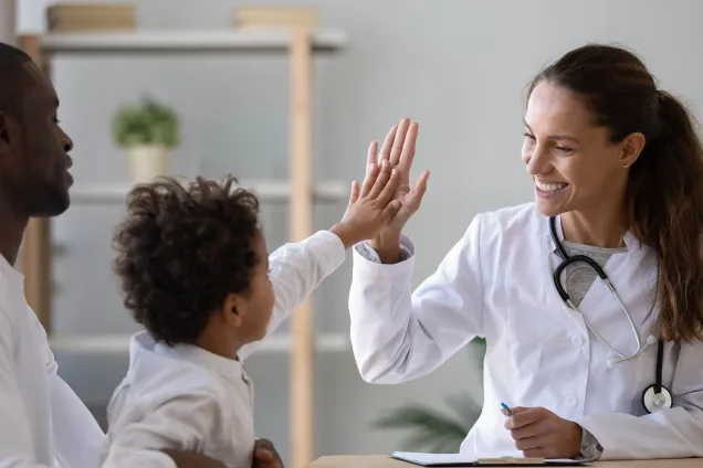 high five between doctor and child 